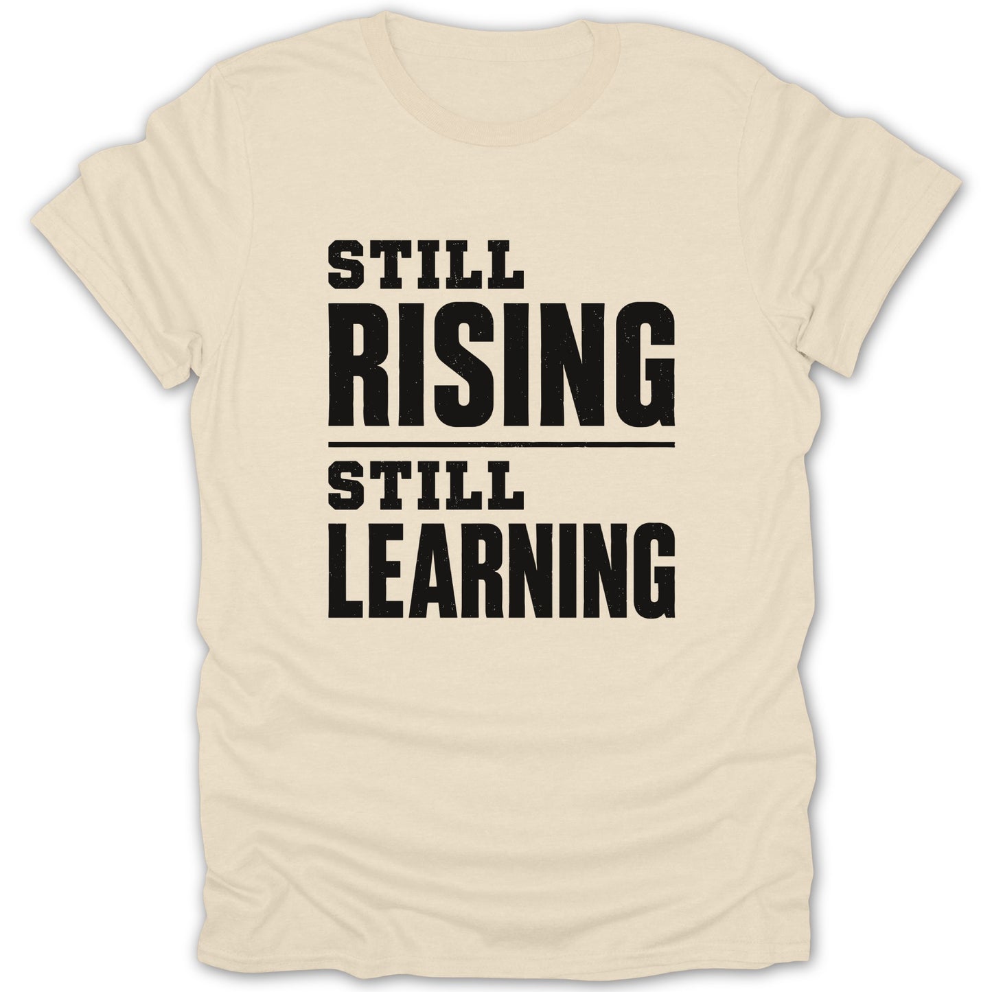 Cream t-shirt with black text "STILL RISING STILL LEARNING".