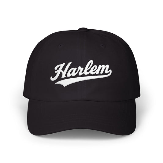 Black baseball cap with white "Harlem" text in a script font.