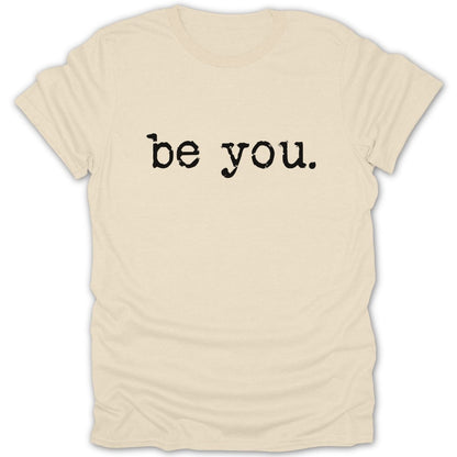 Cream t-shirt with black text reading "be you."