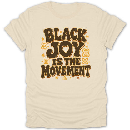 Cream t-shirt with text "BLACK JOY IS THE MOVEMENT" in brown lettering.