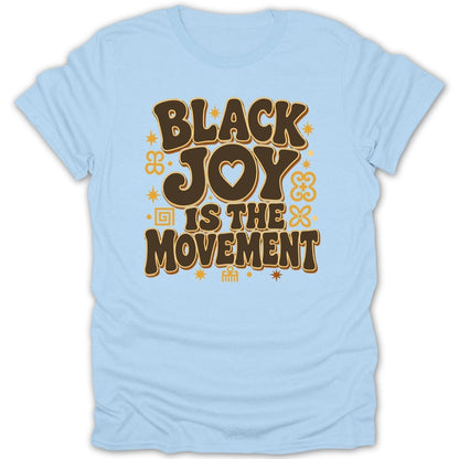 Black Joy Is The Movement text on a light blue t-shirt with decorative elements.