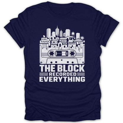Dark blue t-shirt with white graphic of a cassette tape and city skyline. Text reads "THE BLOCK RECORDED EVERYTHING".
