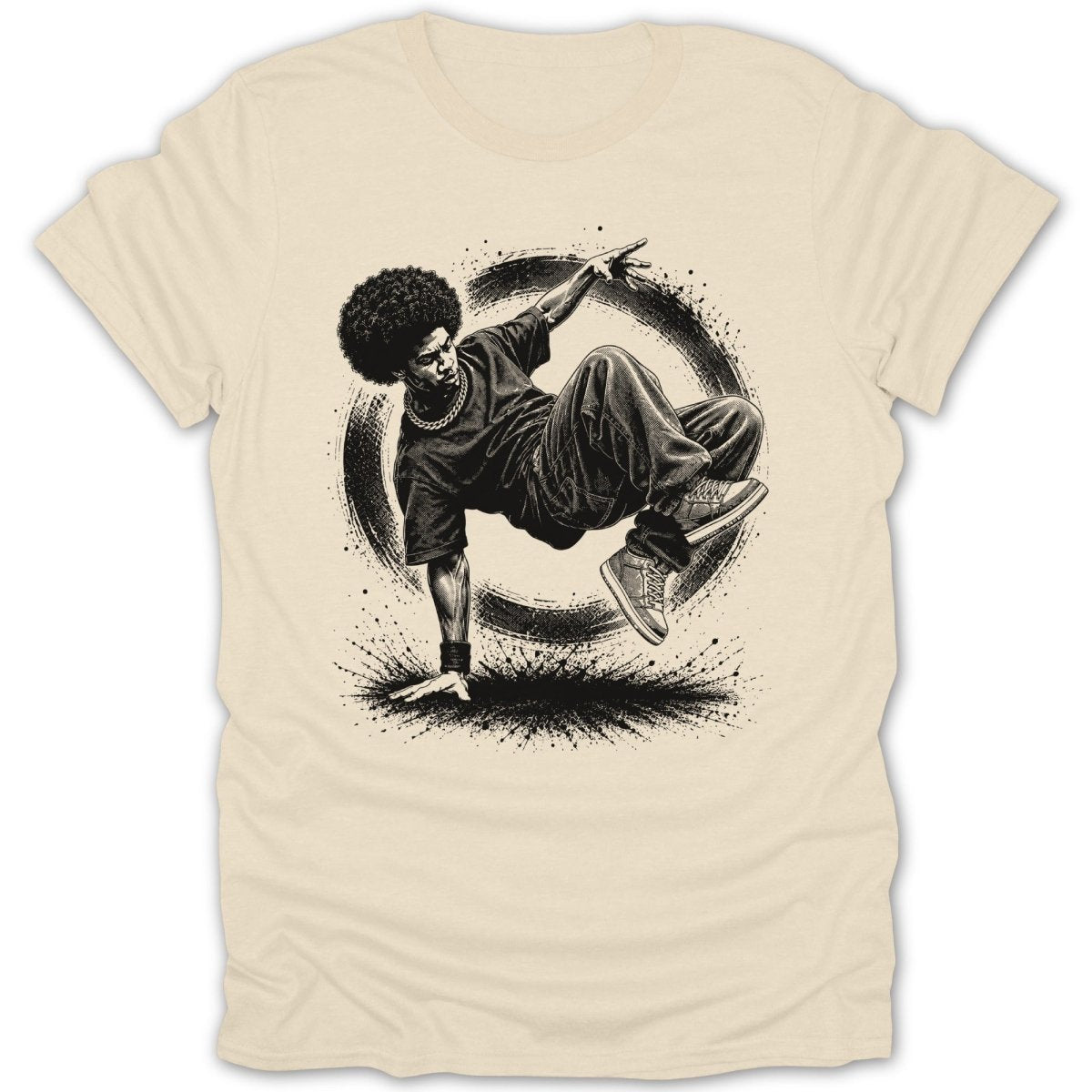 Breakdancer with afro performs a move on a tan t-shirt with black graphic.