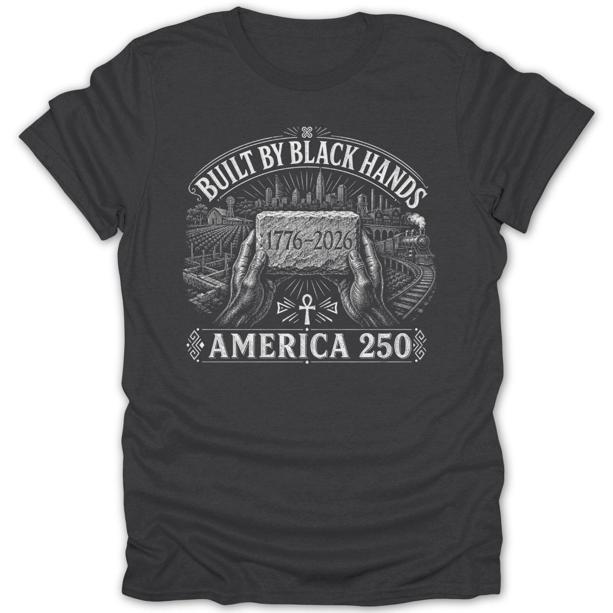 Dark t-shirt with "Built by Black Hands" text, hands holding a brick, and cityscape.