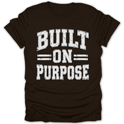 Brown t-shirt with white text reading "BUILT ON PURPOSE" in distressed varsity font.