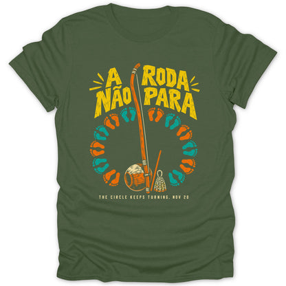 Green t-shirt with "A RODA NÃO PARA" and capoeira instruments.