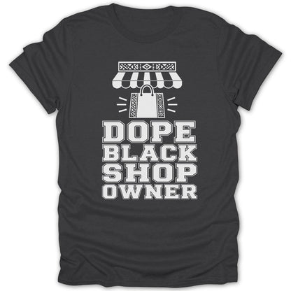 Dark gray t-shirt with white text and graphics that read "DOPE BLACK SHOP OWNER".