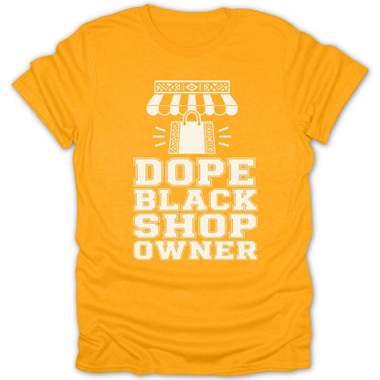 Yellow t-shirt with white text that reads "DOPE BLACK SHOP OWNER" above a shopping bag illustration.