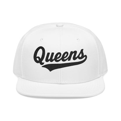 White flat-brimmed cap with "Queens" written in black script.
