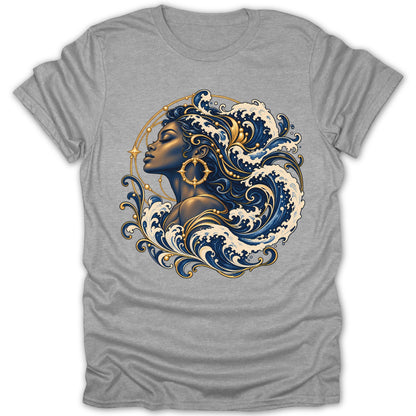 Graphic of a woman with flowing hair made of waves and gold accents on a grey t-shirt.