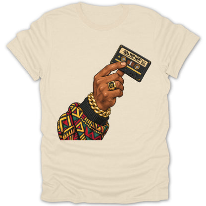 Hand holding a cassette tape labeled "90s HIP HOP" on a cream t-shirt.