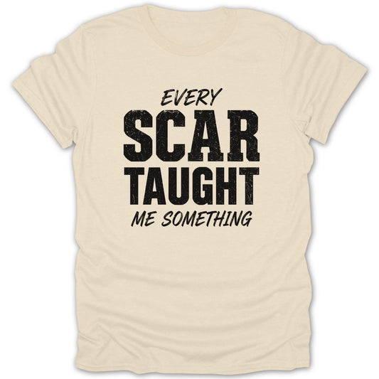 Cream t-shirt with black text: "EVERY SCAR TAUGHT ME SOMETHING."