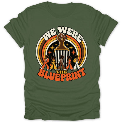 Green t-shirt with "We Were The Blueprint" and vintage-style figures walking.