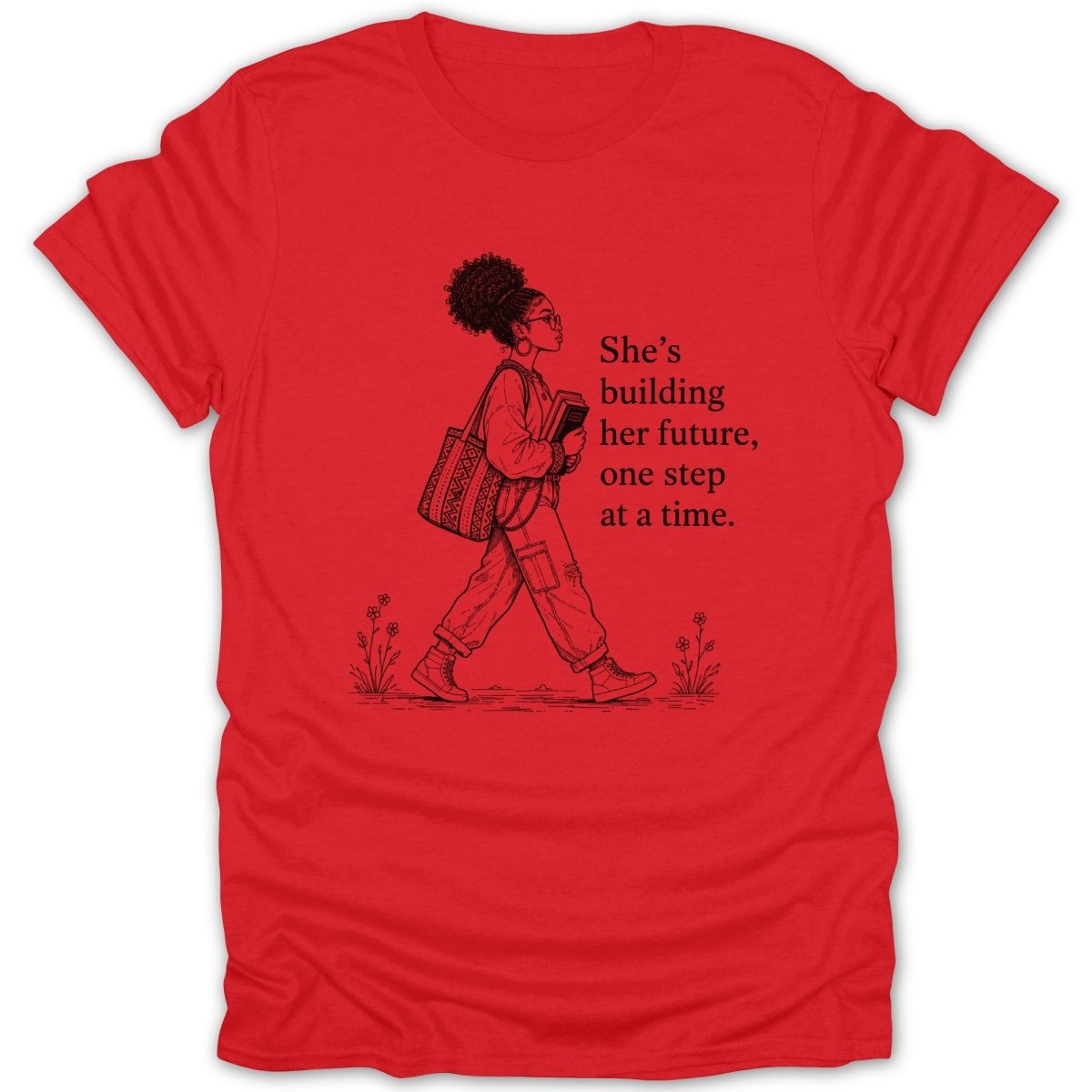 Red t-shirt with graphic of woman walking and text "She's building her future, one step at a time."