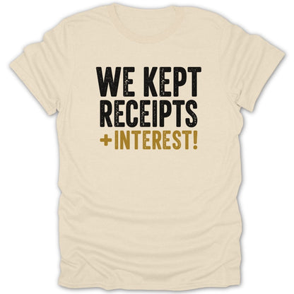Cream t-shirt with black and gold text reading "WE KEPT RECEIPTS + INTEREST!"
