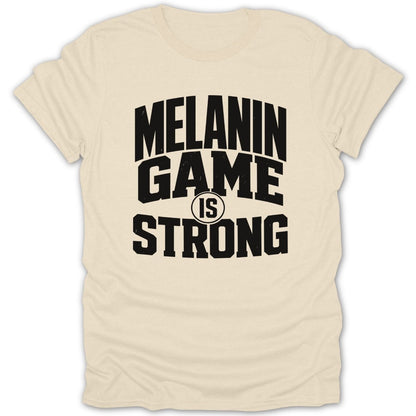 Cream t-shirt with black text "MELANIN GAME IS STRONG"