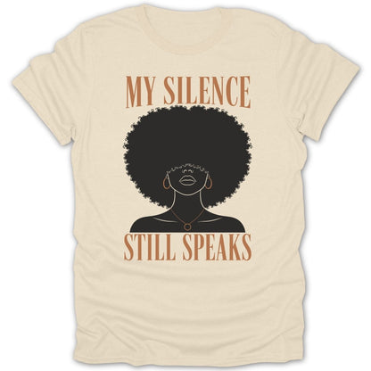 Cream t-shirt with text "MY SILENCE STILL SPEAKS" and a silhouette of a Black woman.