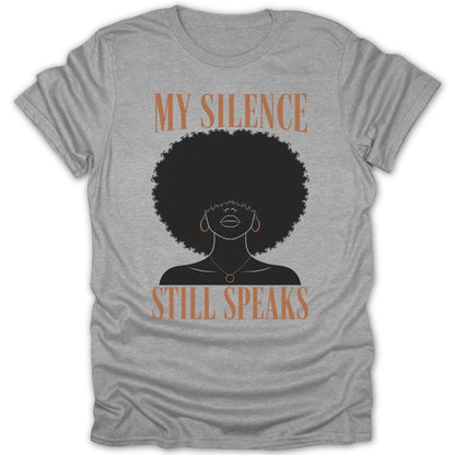 Grey t-shirt with a silhouette of a woman with an afro, reading "My Silence Still Speaks."