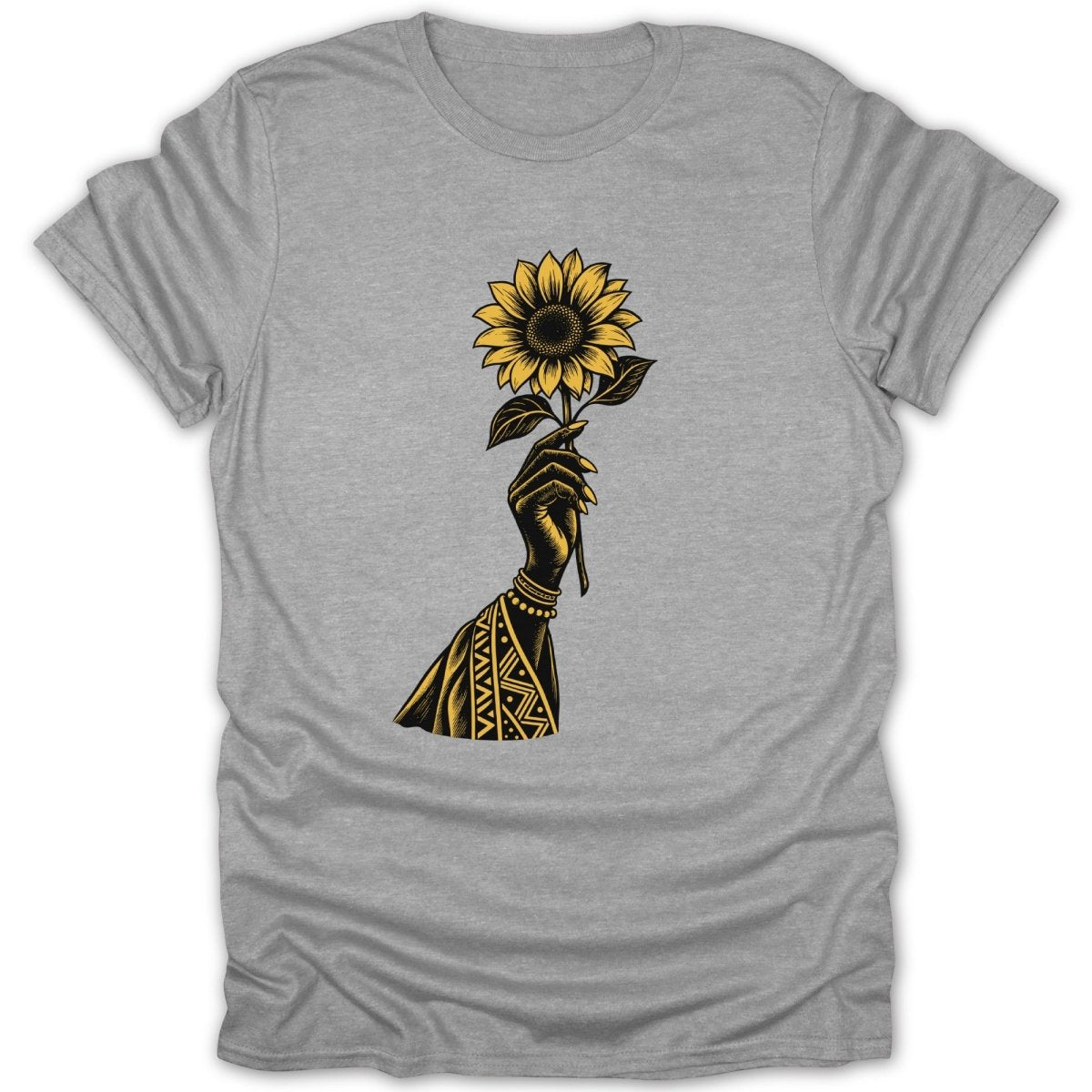 Black hand with geometric patterns holding a yellow sunflower on a grey t-shirt.