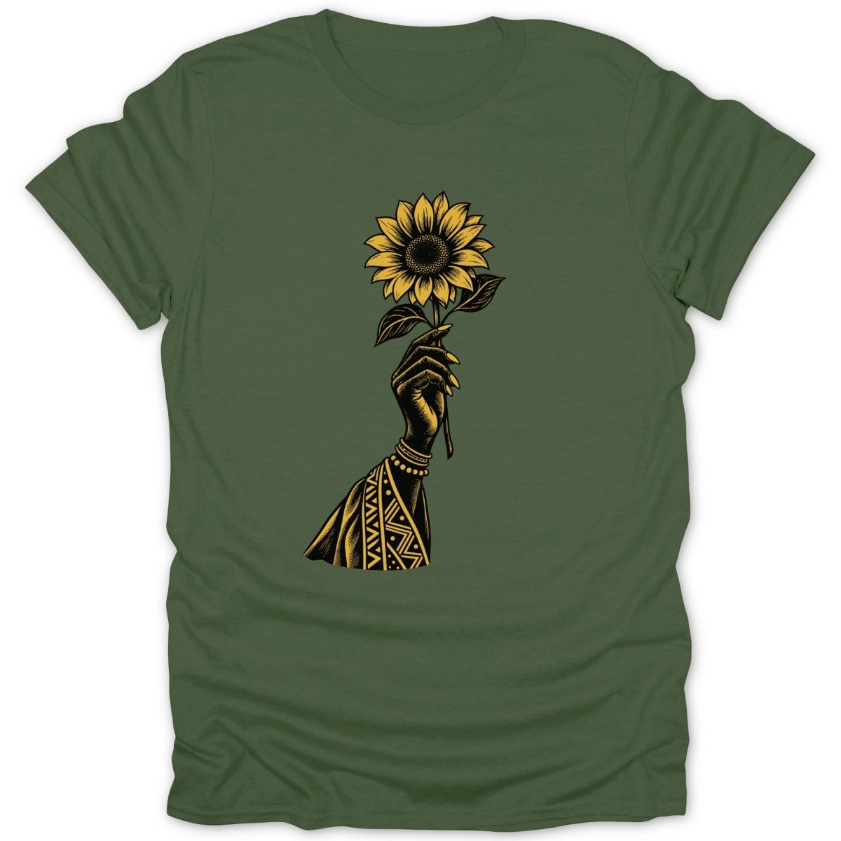 Hand holding a sunflower with tribal patterns on sleeve on green t-shirt.