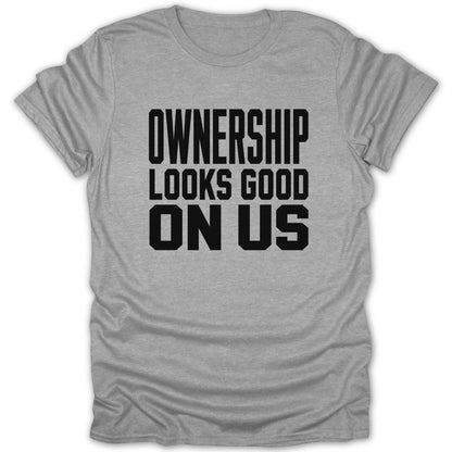 Gray t-shirt with black text "OWNERSHIP LOOKS GOOD ON US".