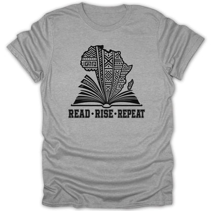 Gray t-shirt with black graphic of Africa on an open book. Text reads: READ • RISE • REPEAT.