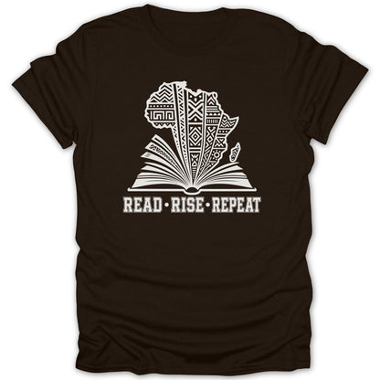 Dark t-shirt with open book featuring Africa map and "READ RISE REPEAT" text.