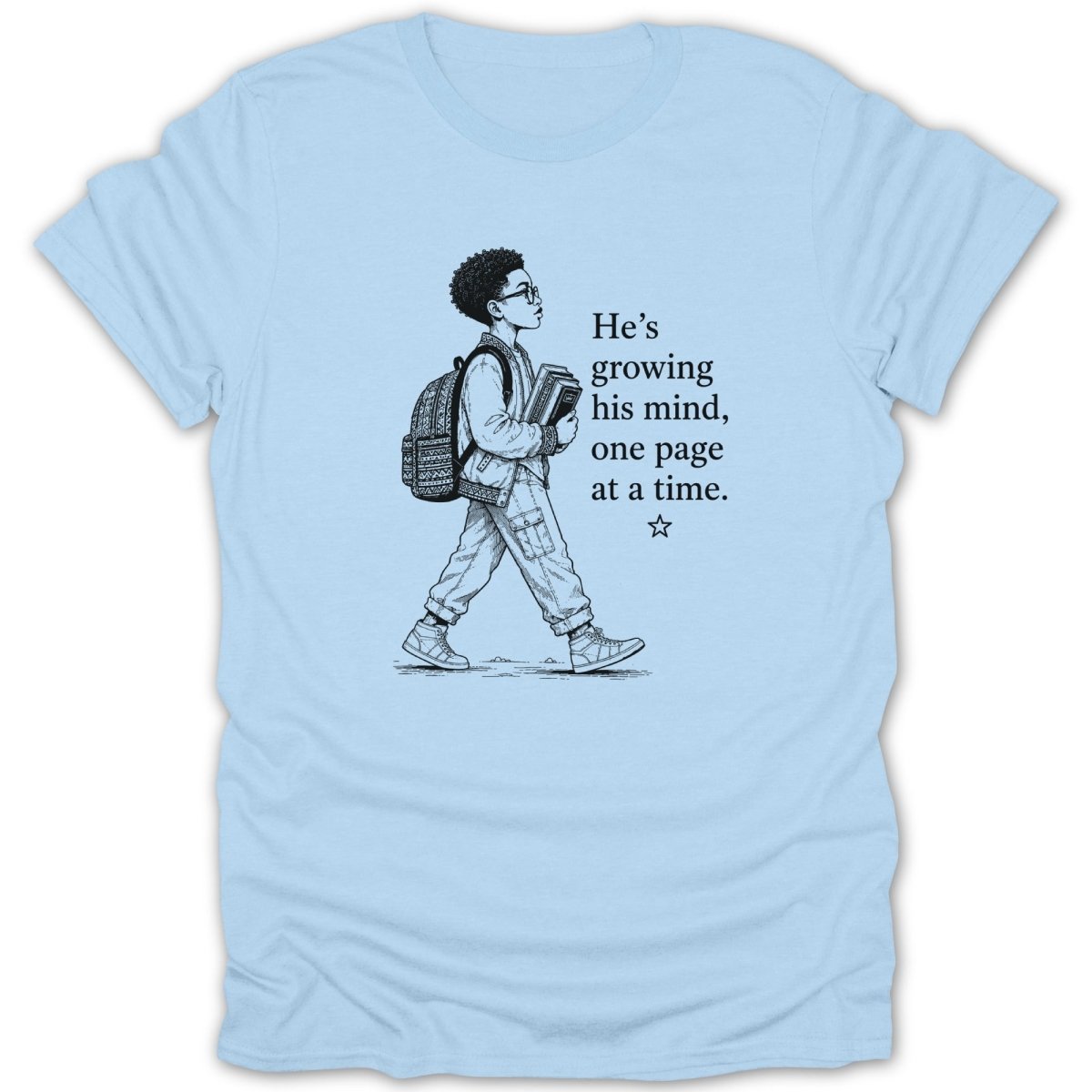 Light blue t-shirt with graphic of boy reading and text "He's growing his mind, one page at a time."