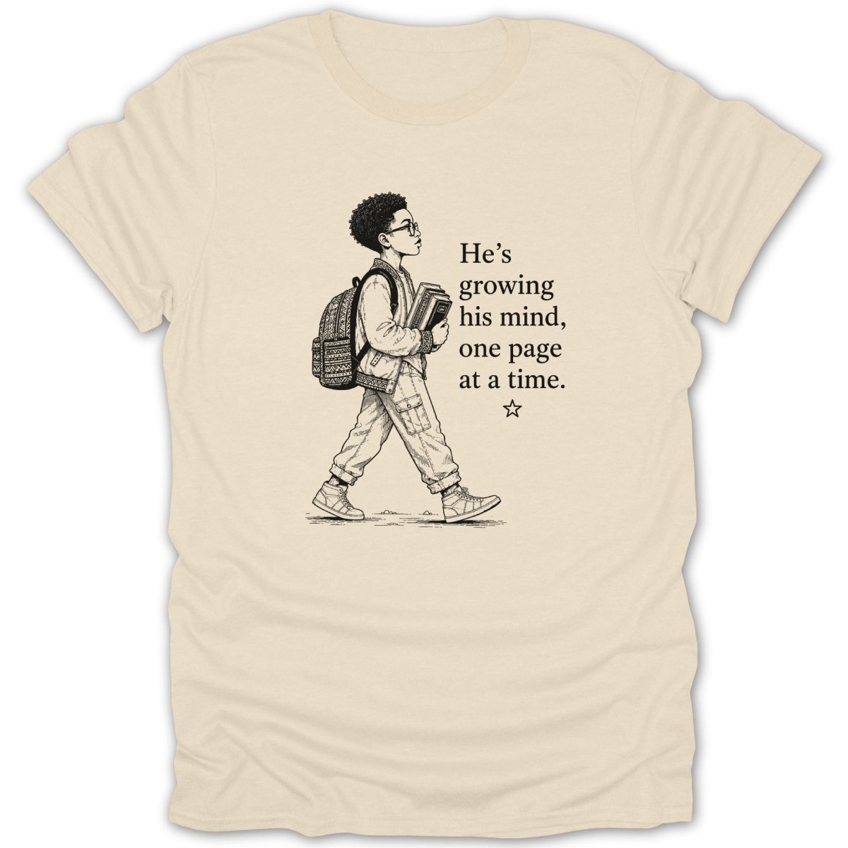 T-shirt with sketch of boy holding books and text "He's growing his mind, one page at a time."