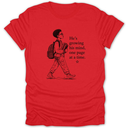 Red t-shirt with illustration of boy and text "He's growing his mind, one page at a time."
