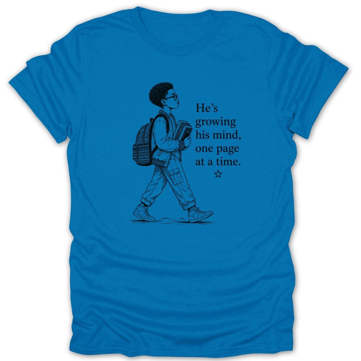 Blue t-shirt with illustration of boy carrying books and text "He's growing his mind, one page at a time."