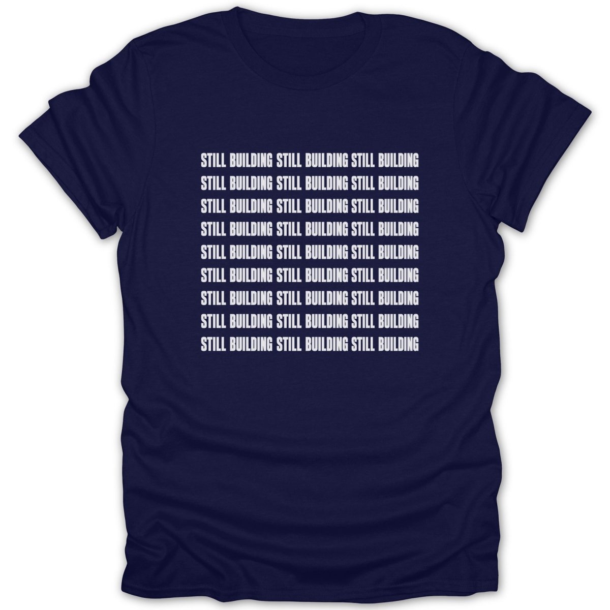 Navy t-shirt with repeating "STILL BUILDING" text in white on the front.