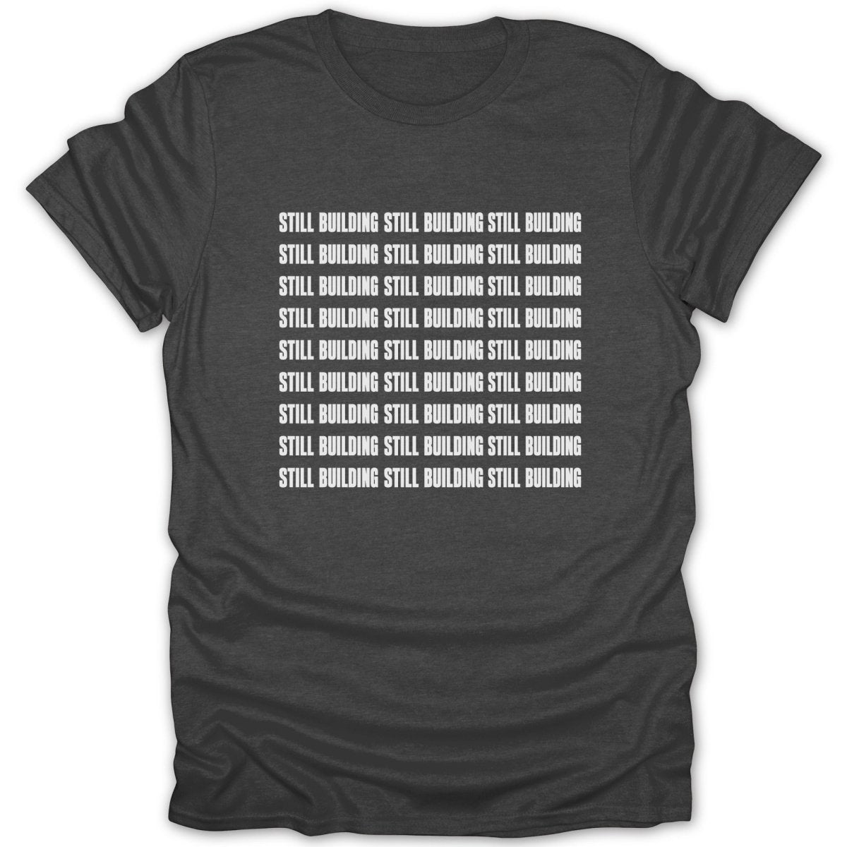 Dark gray t-shirt with repeating white text that reads "STILL BUILDING".