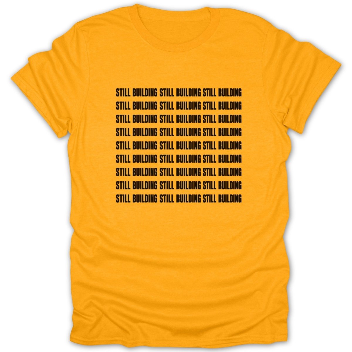 Orange t-shirt with black text repeating "STILL BUILDING" in rows.