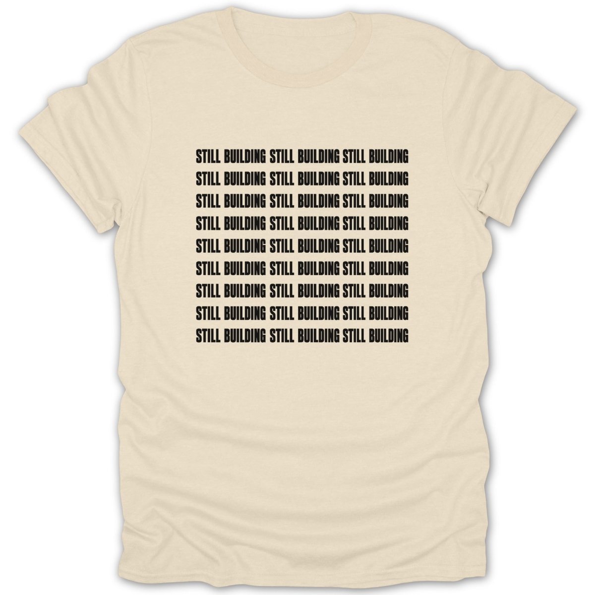 Cream t-shirt with repeated black text "STILL BUILDING".