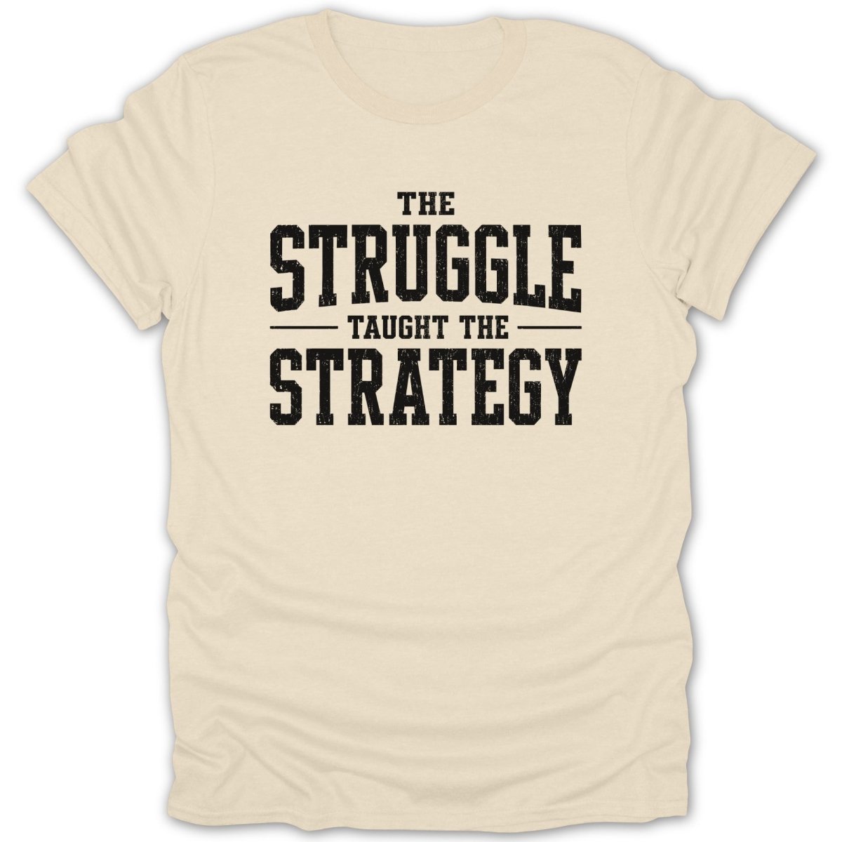 Cream t-shirt with black text "The Struggle Taught The Strategy"