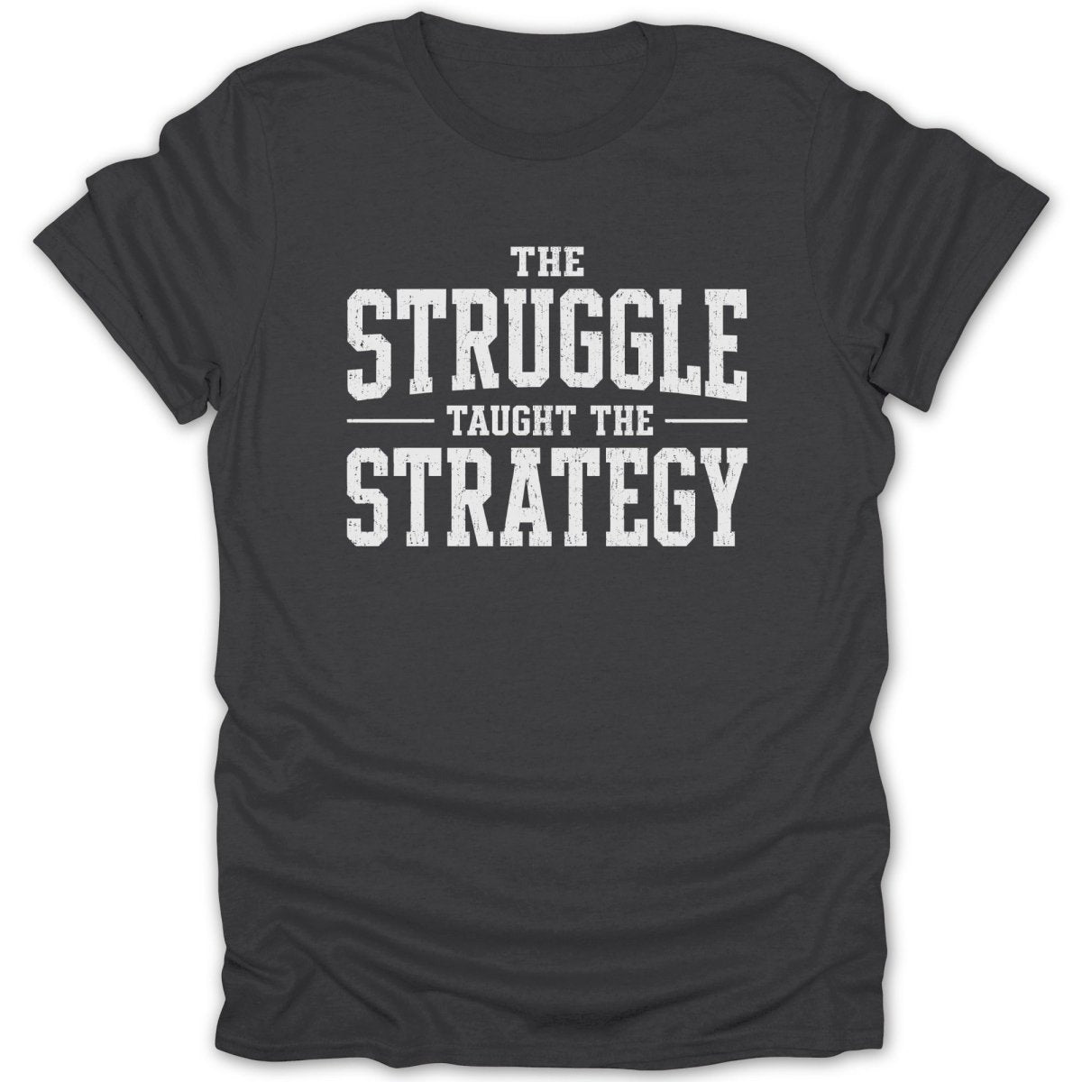 Dark gray t-shirt with white text: THE STRUGGLE TAUGHT THE STRATEGY.