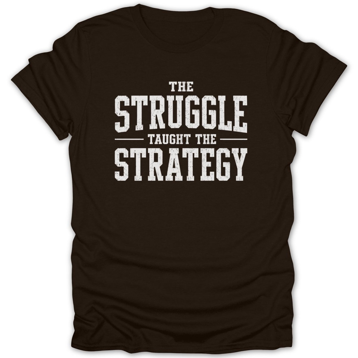 Brown t-shirt with white text reading "The Struggle Taught The Strategy".