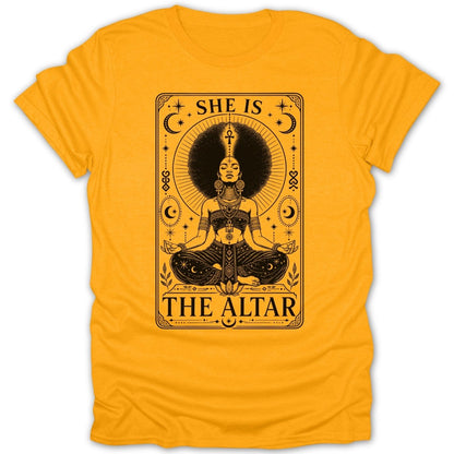 Black graphic on yellow t-shirt reads "SHE IS THE ALTAR" with meditating woman.