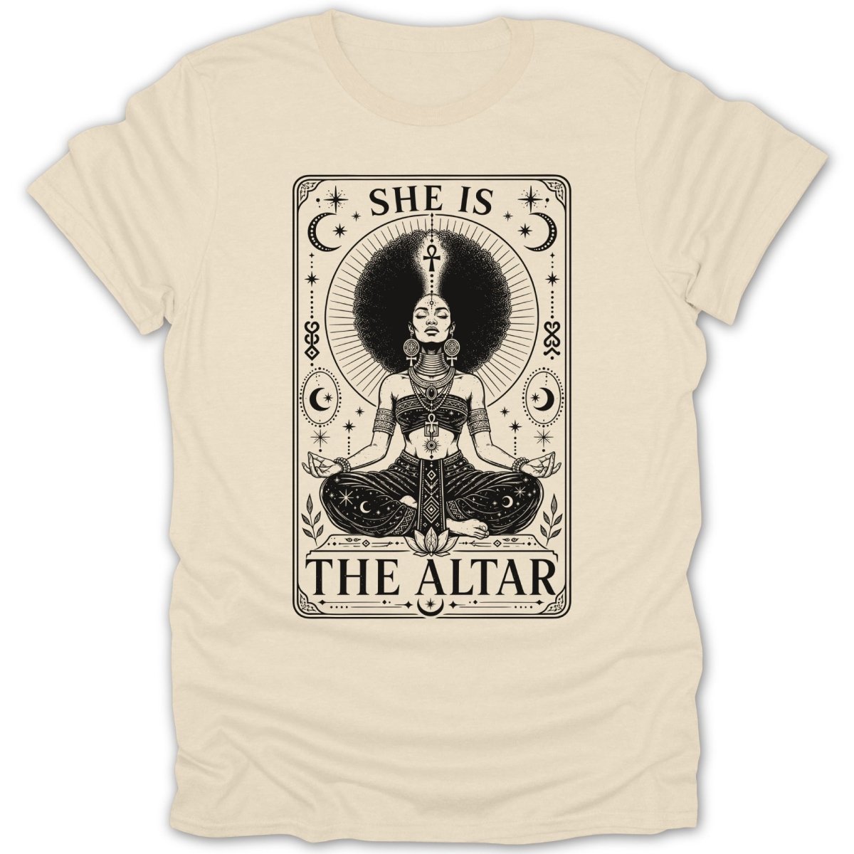 A woman with a large afro meditates on a shirt with text "SHE IS THE ALTAR".