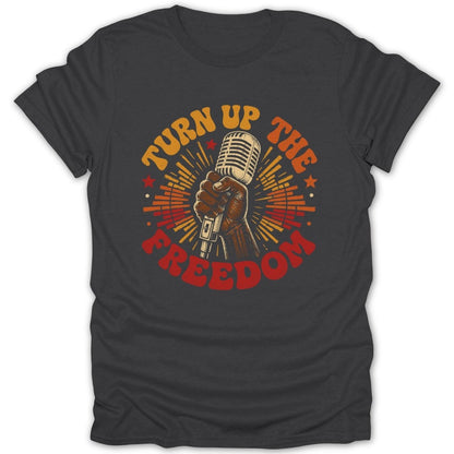 Dark gray t-shirt with retro graphic of hand holding microphone and text "Turn Up The Freedom".