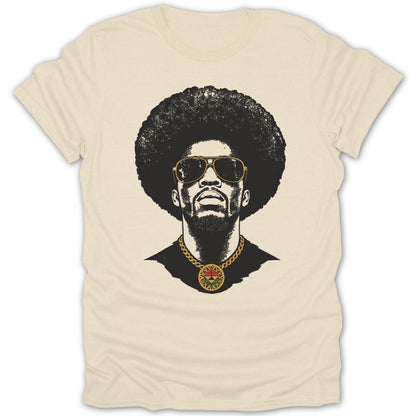 Black graphic print of a man with an afro, sunglasses, and a medallion on a cream t-shirt.