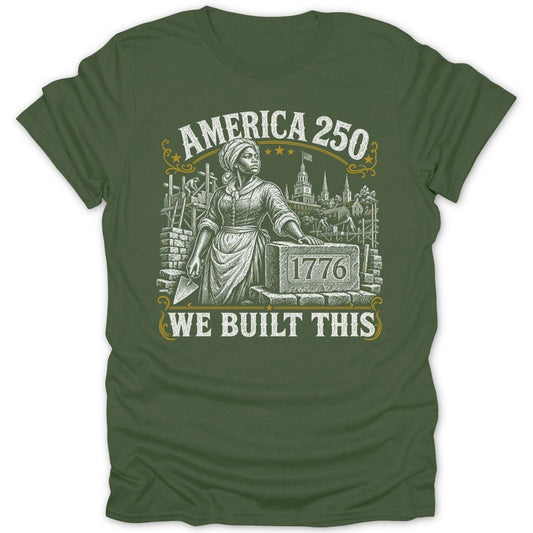 America 250 t-shirt with woman building brick wall and town in background.